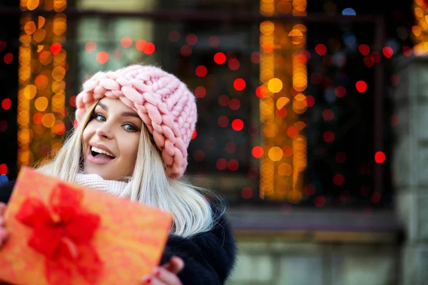 Funny Blonde Woman Wearing Fur Coat Cap Pulls Gift Box — Stock Photo, Image