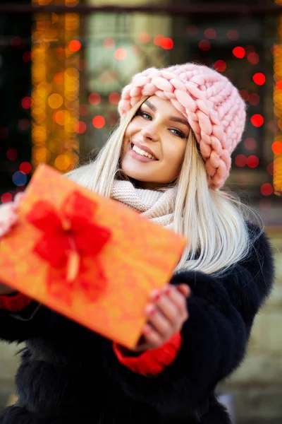 Merry Young Woman Wearing Fur Coat Cap Pulls Gift Box — Stock Photo, Image