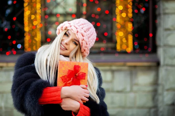 Awesome Blonde Woman Wearing Knitted Cap Warm Coat Holding Gift — Stock Photo, Image