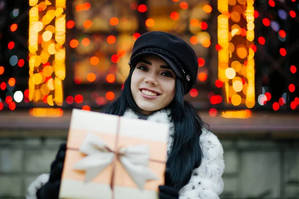 Joyful Young Woman Wearing Fur Coat Cap Pulls Gift Box — Stock Photo, Image