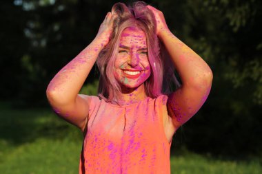 Parkta bir renkli kuru boya ile kaplı neşeli model poz Closeup çekim