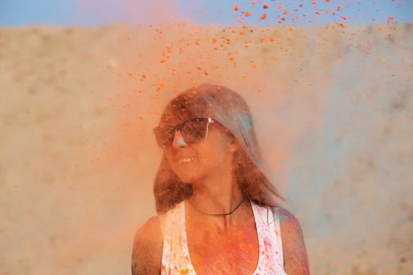 사막에서 그녀의 오렌지 Holi 폭발과 선글라스를 긍정적인 — 스톡 사진