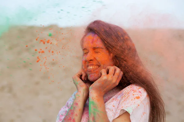 Closeup Portrait Happy Brunette Woman Playing Exploding Orange Holi Paint — Stock Photo, Image