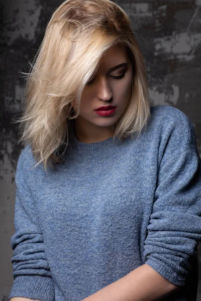 Stylowa Blond Kobieta Bujnymi Włosami Ubrana Niebieski Sweter Stwarzając Studio — Zdjęcie stockowe