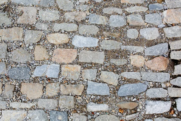 Stone road texture with gravel. Closeup shot