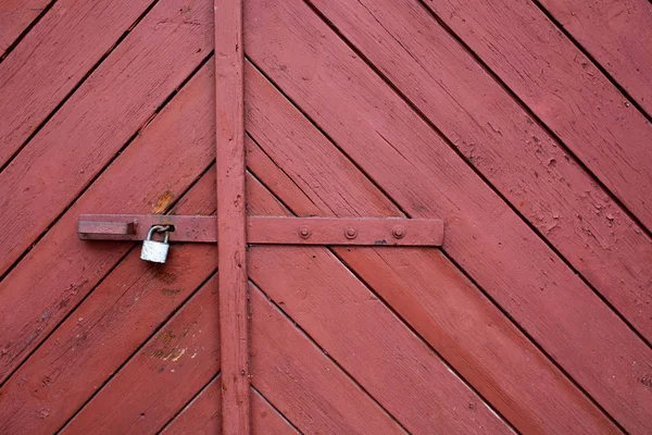 Wooden scratched gates with a metal lock. Copy space