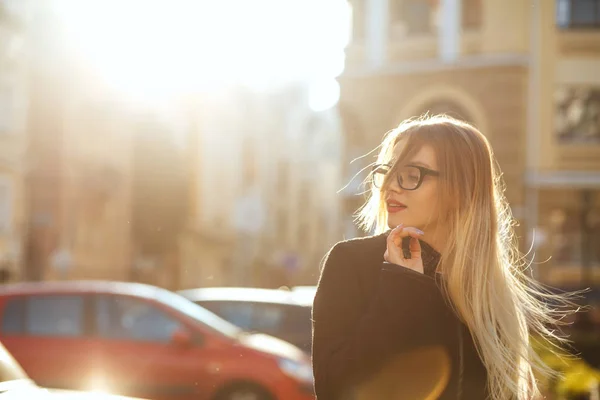 Radosny model blondynka nosi okulary i schodząc w dół ulicy słonecznej. — Zdjęcie stockowe
