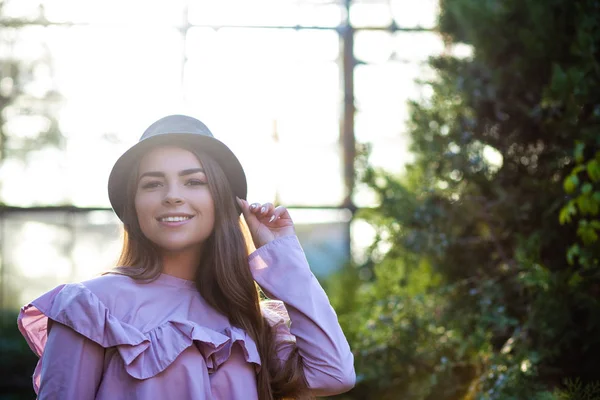Adorable chica bronceada con blusa y sombrero de moda, posando outdo — Foto de Stock