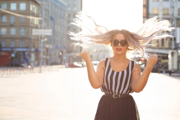 Cool blond kvinna med vind i håret poserar med mjuk sol ljus. — Stockfoto