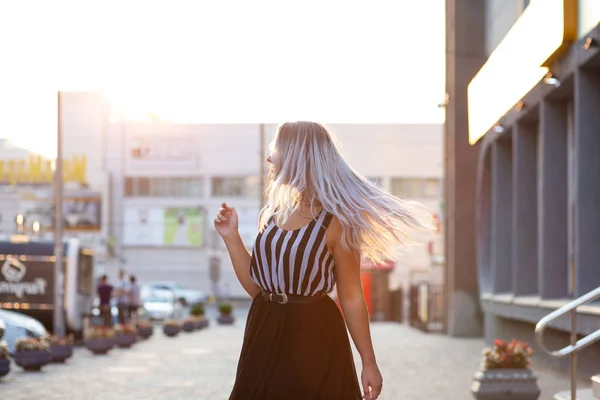 Stylish blonde model with fluttering hair posing with evening li — Stock Photo, Image