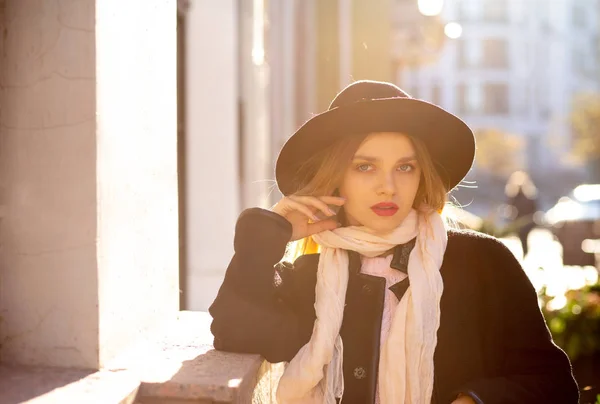 Stunning blonde woman wearing coat and hat posing at the old str — Stock Photo, Image