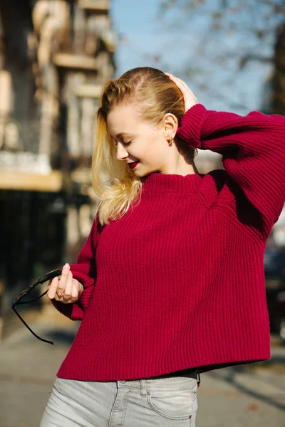 Nice young woman with red lips wearing knitted sweater posing in — Stock Photo, Image