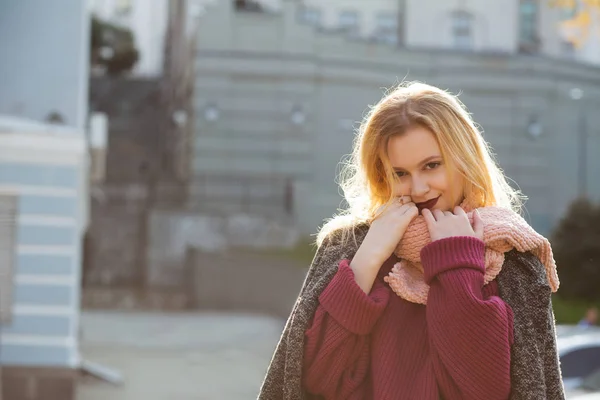 Tender blonde model wearing coat and scarf, posing with soft bac — Stock Photo, Image