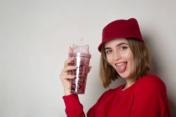 Grappige brunette vrouw in Red Hat houden Cherry Juice glas en s — Stockfoto