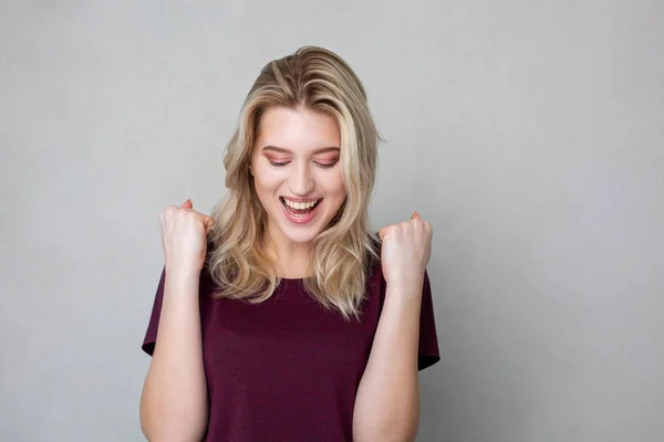 Mujer rubia bastante sorprendida celebrando el éxito. Espacio para texto — Foto de Stock