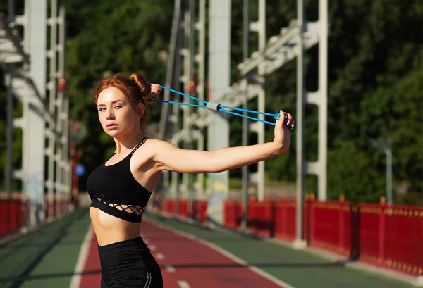 Preciosa mujer atlética haciendo ejercicio de estiramiento en el puente i — Foto de Stock