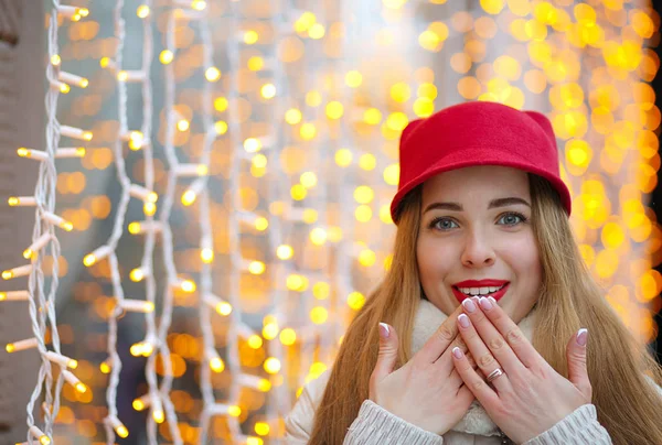 Smiling woman in cap covering her mouth — Stock Photo, Image