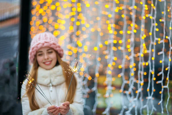 Cheerful girl holding bengal lights — Stock Photo, Image