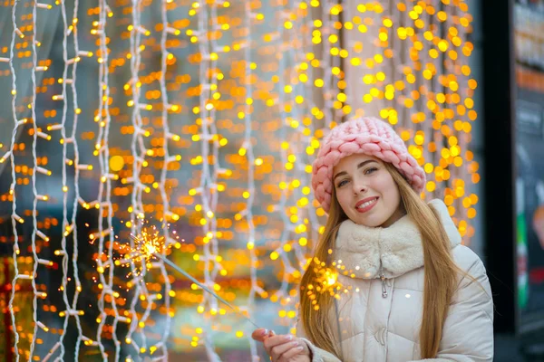 Pleased girl holding bengal lights — Stock Photo, Image