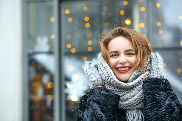 Positive young woman walking in snowy weather — Stock Photo, Image