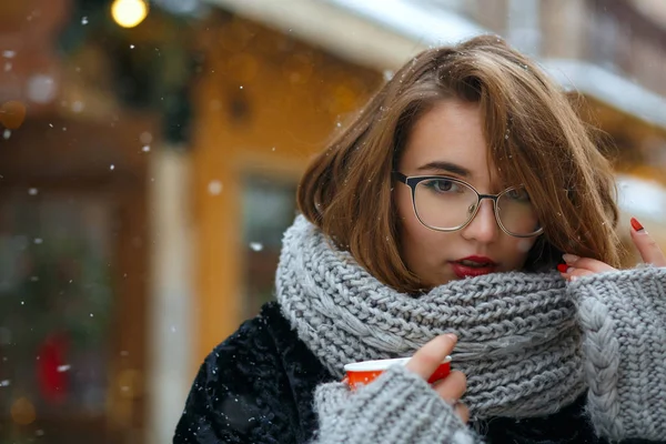 Wonderful girl wears warm scarf drinks tea — Stock Photo, Image