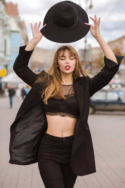 Seductive woman wears lingerie and holding hat