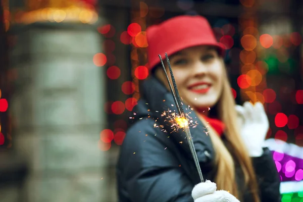 Joyful girl holding sparkler — Stock Photo, Image