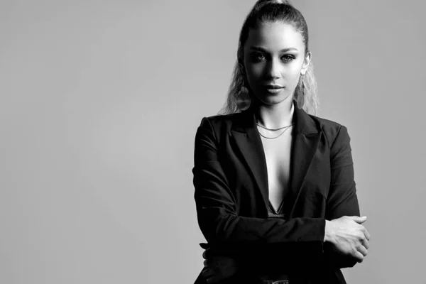 一个自信的女人穿着灰色背景的夹克的黑白工作室肖像 案文的篇幅 — 图库照片