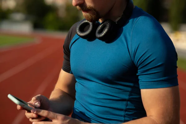 Closeup Shot Young Man Athlete Headphones His Neck Typing Text — Stock Photo, Image