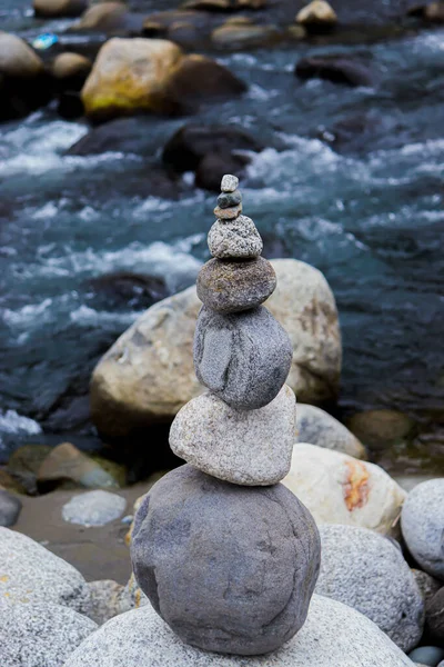 Rock Balancing: Stone Stacking Art having flowing river in the background