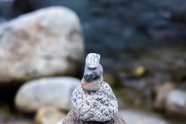 Rock Balancing: Stone Stacking Art having flowing river in the background