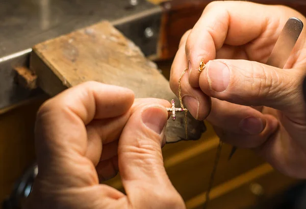 Hands of a craftsman jeweler working on jewelry. Goldsmith.Goldsmith workshop jewels and articles of work value