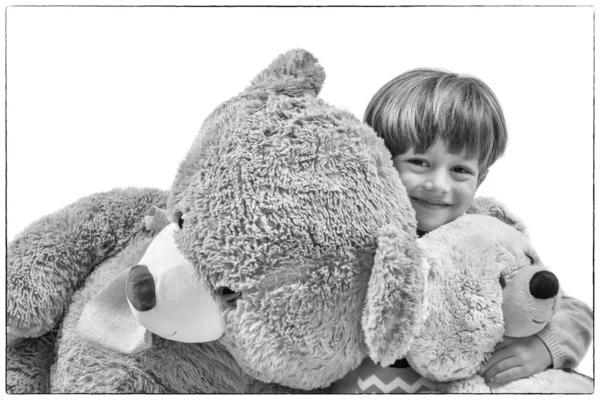 Little boy playing with big teddy bears