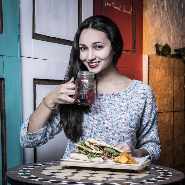 Beautiful woman with smile, eating at old restaurants