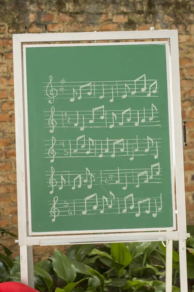 musical notes on green chalkboard