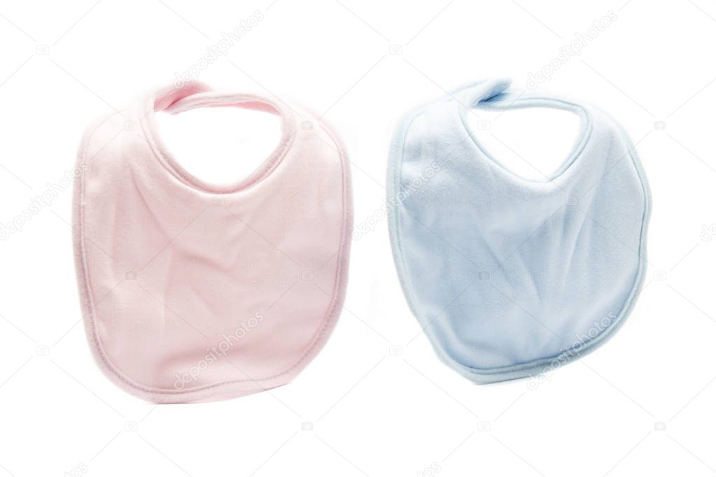 Baby bibs of various colors on white background