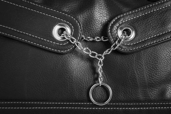 Leather texture background with chain and ring