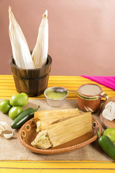 Typical Mexican food dishes with sauces on colorful table.