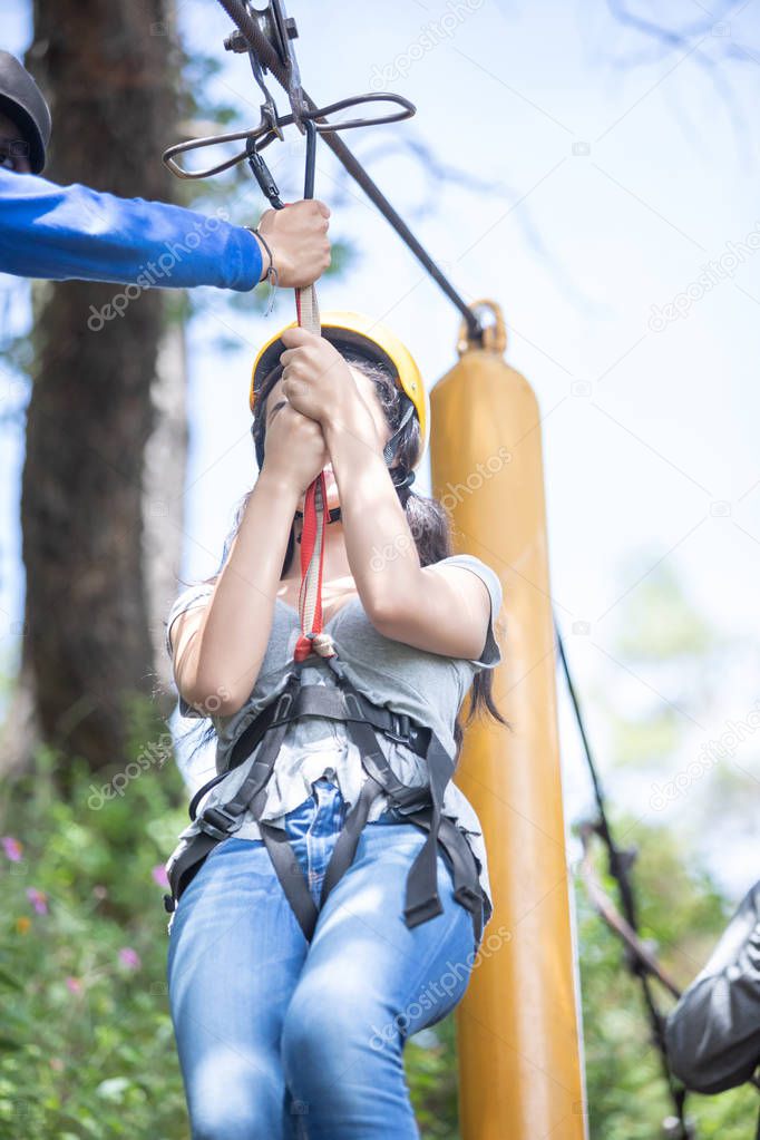 Girl pulling the zip line in the forest of Mazamitla