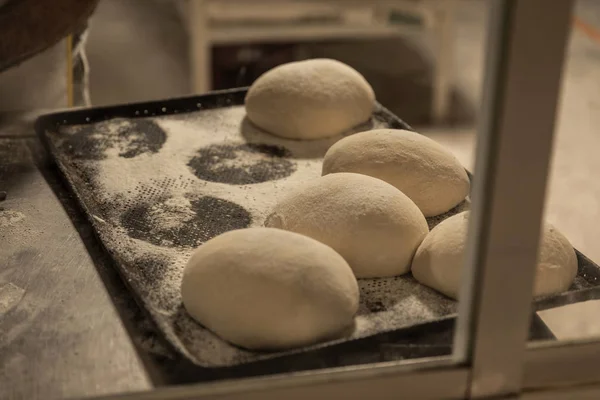 Hands of the master baker in bread production — Stock Photo, Image