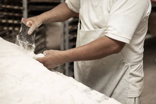 Hands of the master baker in bread production — Stock Photo, Image
