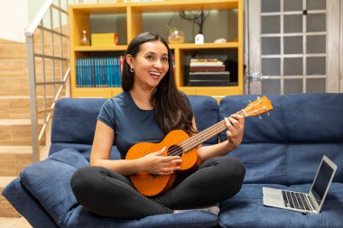 COVID-19 hastalıklı genç bir kadın karantinada. İnternetten gitar dersi alan bir kadın