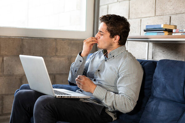 handsome and elegant man doing home office during the COVID-19 pandemic. Receiving news