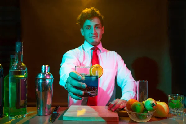 Barman preparing drink with shaker