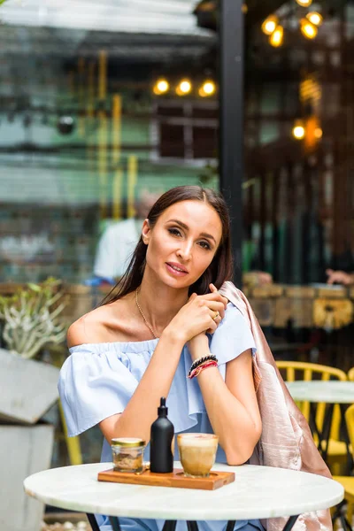 Young pretty woman using smartphone in cafe, drink coffee in cup, sweet breakfast, happy face, outdoor hipster portrait, fashion girl, table, sweet drink, tasty tea, aromatic coffee, smoothie health