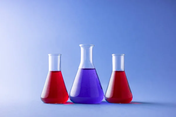 Tre Erlenmeyer Kolvar Över Färgstarka Bakgrund — Stockfoto