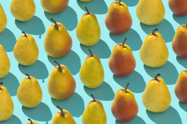 Birden çok armut mavi arka plan üzerinde bir satırda düzenlenen