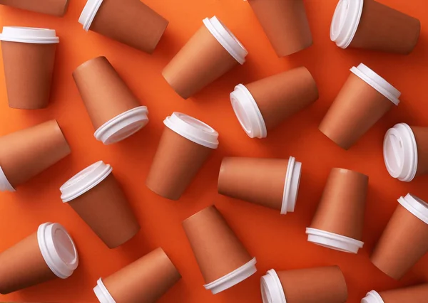 Multiple Disposable Coffee Cups Disorganized Orange Background — Stock Photo, Image