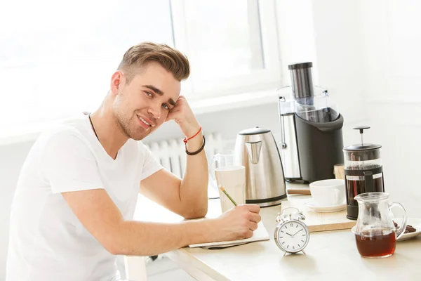 Morning. Young man by the table