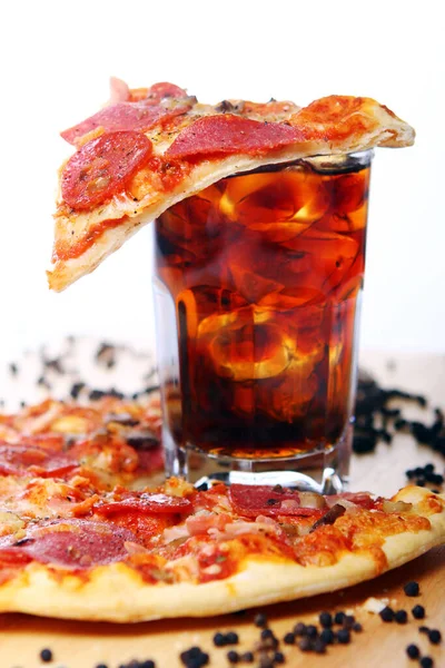 Fresh pizza with salami and mushrooms and cold cola drink